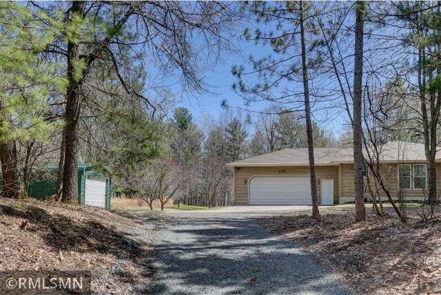 890 Lincoln Ave, Amery, WI 54001 - view of home's exterior featuring an attached garage and gravel driveway