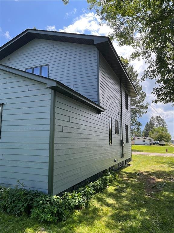 view of side of home featuring a yard
