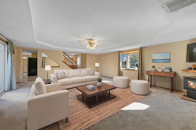 1992 London Rd, Green Bay, WI 54311 - living area featuring visible vents, wood finished floors, baseboards, stairway, and a textured ceiling