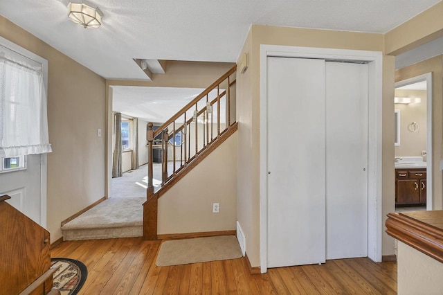 1992 London Rd, Green Bay, WI 54311 - staircase featuring visible vents, baseboards, and hardwood / wood-style flooring