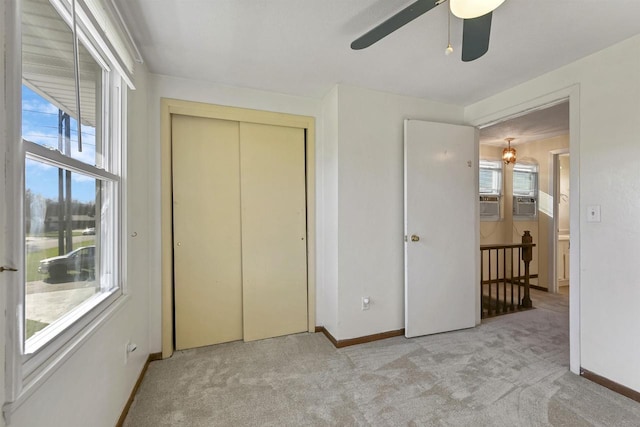 1992 London Rd, Green Bay, WI 54311 - unfurnished bedroom with baseboards, light colored carpet, multiple windows, and a closet
