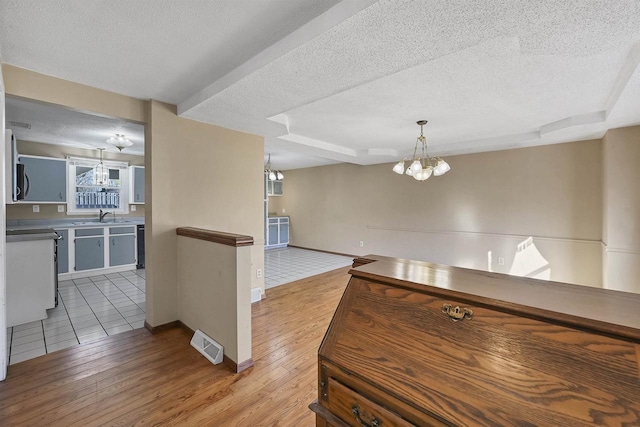1992 London Rd, Green Bay, WI 54311 - kitchen featuring a notable chandelier, a textured ceiling, and visible vents