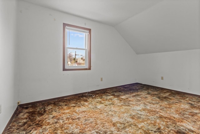 bonus room with baseboards, carpet, and vaulted ceiling