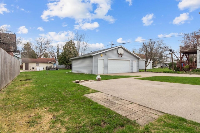 view of yard featuring a garage and an outbuilding