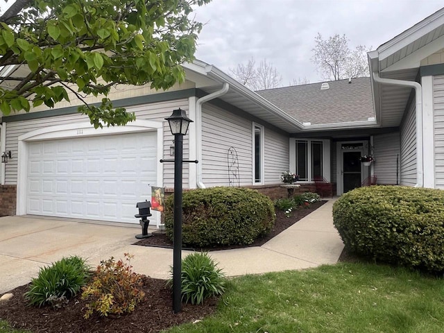 1111 Virgin Lake Dr, Stoughton, WI 53589 - view of side of property with driveway, a shingled roof, and an attached garage
