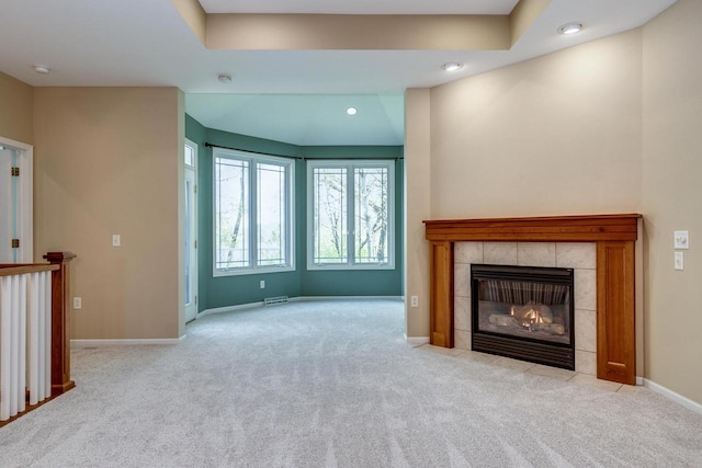 1111 Virgin Lake Dr, Stoughton, WI 53589 - unfurnished living room featuring carpet flooring, a tiled fireplace, baseboards, and recessed lighting