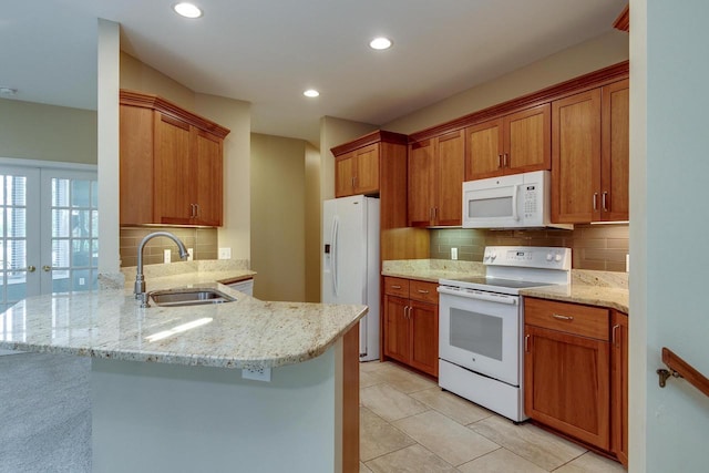 1111 Virgin Lake Dr, Stoughton, WI 53589 - kitchen featuring white appliances, a sink, a peninsula, backsplash, and recessed lighting