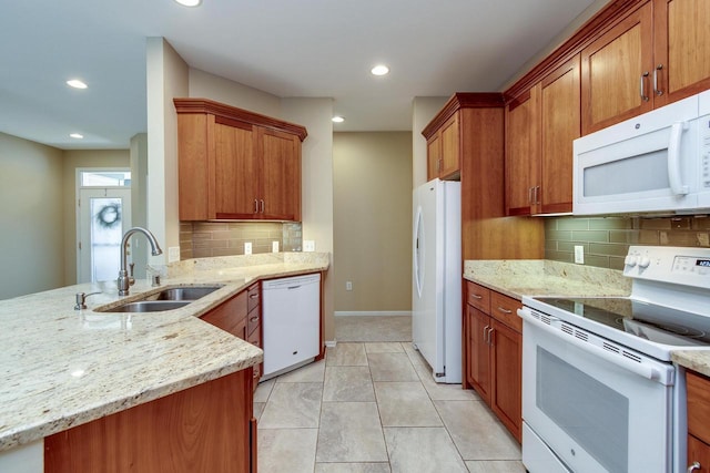 1111 Virgin Lake Dr, Stoughton, WI 53589 - kitchen with white appliances, a sink, light stone countertops, and recessed lighting