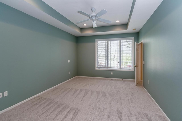 1111 Virgin Lake Dr, Stoughton, WI 53589 - spare room featuring a raised ceiling, carpet flooring, a ceiling fan, baseboards, and recessed lighting