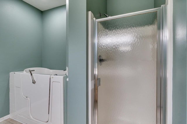 1111 Virgin Lake Dr, Stoughton, WI 53589 - full bathroom featuring a shower stall, a bath, and tile patterned flooring