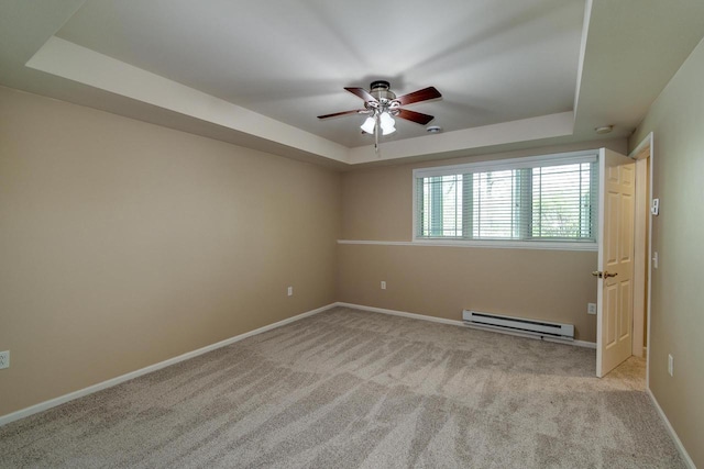 1111 Virgin Lake Dr, Stoughton, WI 53589 - unfurnished room featuring a baseboard heating unit, a tray ceiling, a ceiling fan, carpet flooring, and baseboards