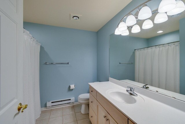 1111 Virgin Lake Dr, Stoughton, WI 53589 - bathroom featuring baseboard heating, toilet, tile patterned flooring, vanity, and baseboards
