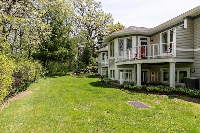1111 Virgin Lake Dr, Stoughton, WI 53589 - view of green lawn featuring a balcony and central air condition unit