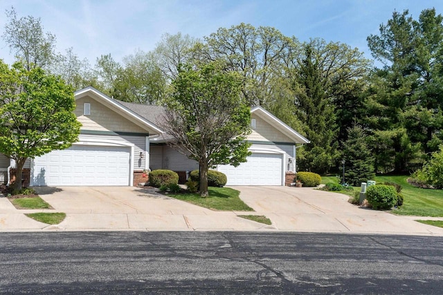 1111 Virgin Lake Dr, Stoughton, WI 53589 - view of property hidden behind natural elements featuring brick siding, driveway, and an attached garage