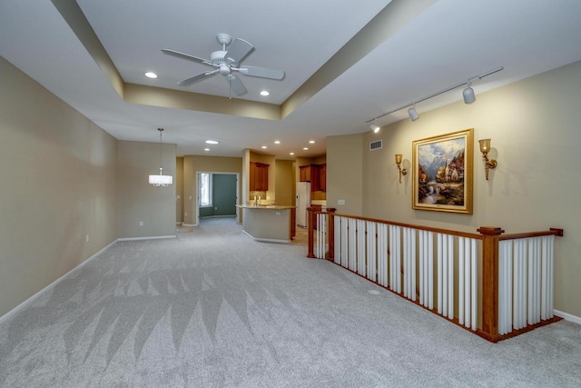 1111 Virgin Lake Dr, Stoughton, WI 53589 - spare room featuring a ceiling fan, light colored carpet, track lighting, baseboards, and recessed lighting