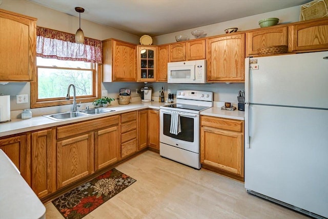 kitchen with a sink, light countertops, glass insert cabinets, light floors, and white appliances