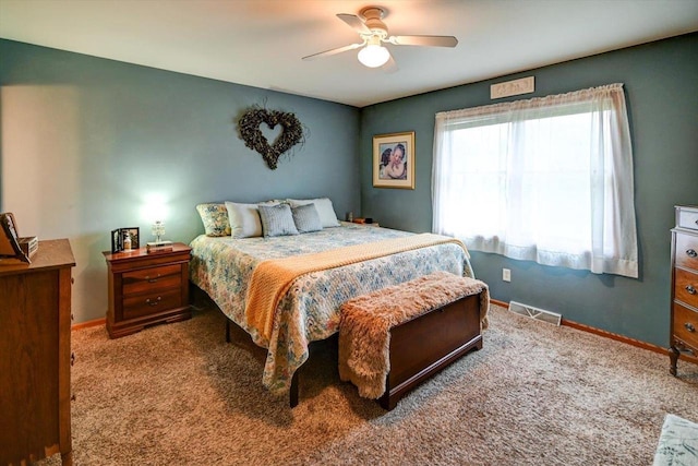 bedroom featuring carpet floors, baseboards, ceiling fan, and visible vents