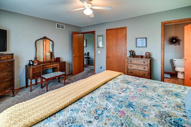 bedroom featuring a ceiling fan, baseboards, visible vents, and ensuite bathroom
