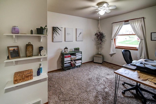 carpeted office featuring baseboards and a ceiling fan