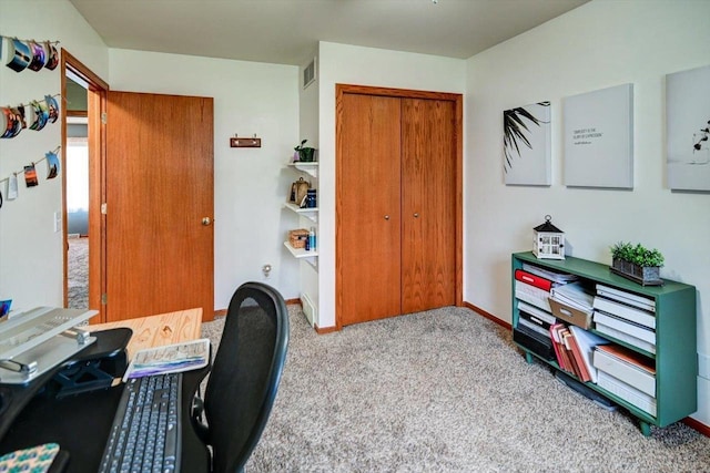 carpeted office with visible vents and baseboards