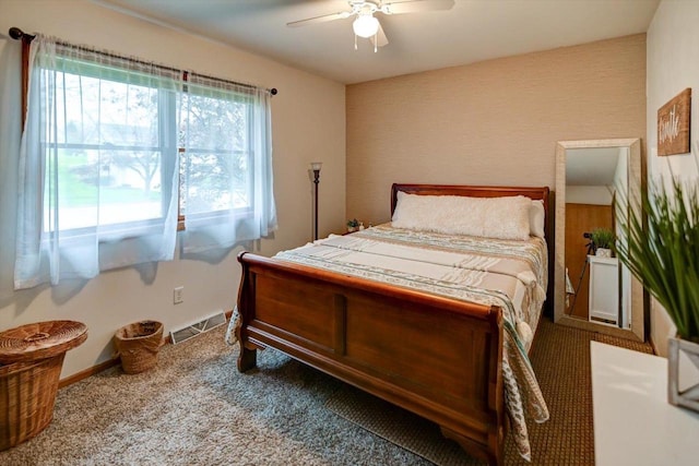 carpeted bedroom featuring a ceiling fan, baseboards, and visible vents