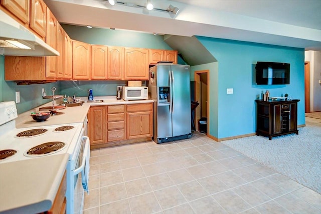 kitchen with light brown cabinetry, light carpet, white appliances, light countertops, and under cabinet range hood