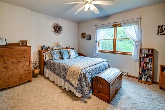 bedroom featuring a ceiling fan, baseboards, a baseboard heating unit, and light carpet