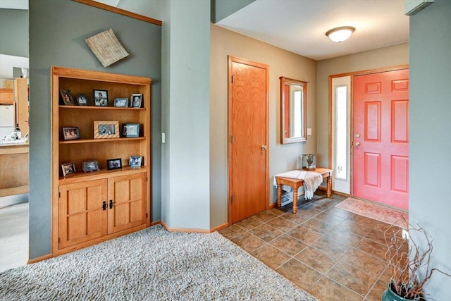 foyer featuring baseboards