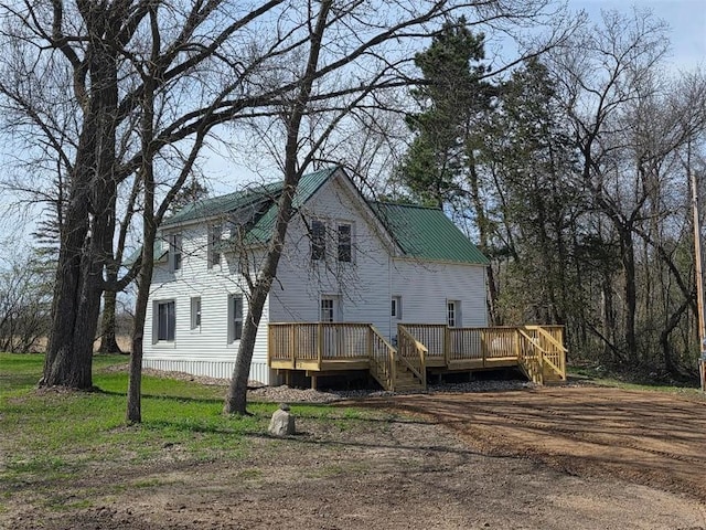 back of house featuring a wooden deck