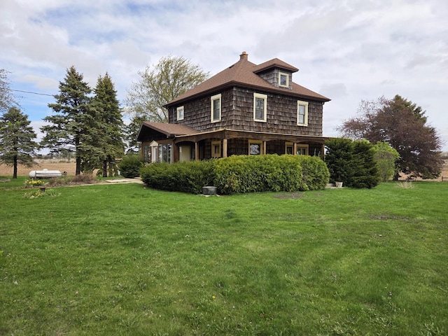 5986 Marsh Rd, Elkhorn, WI 53121 - view of property exterior featuring a lawn and a chimney