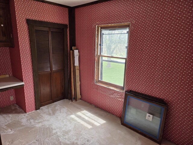 5986 Marsh Rd, Elkhorn, WI 53121 - unfurnished bedroom with a closet, light carpet, and wallpapered walls