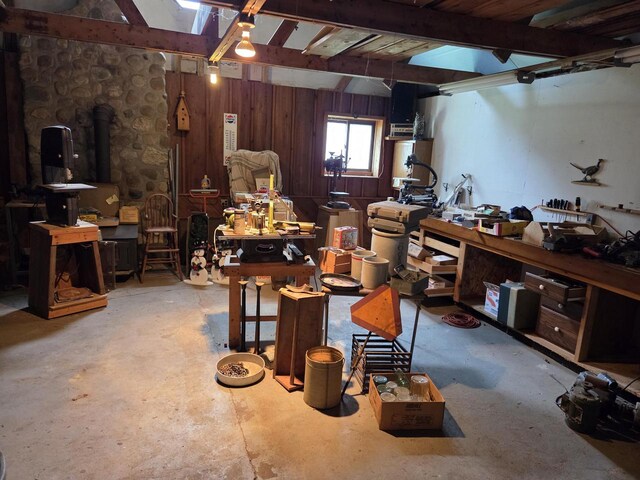 5986 Marsh Rd, Elkhorn, WI 53121 - miscellaneous room featuring concrete floors, wooden walls, a workshop area, and beamed ceiling