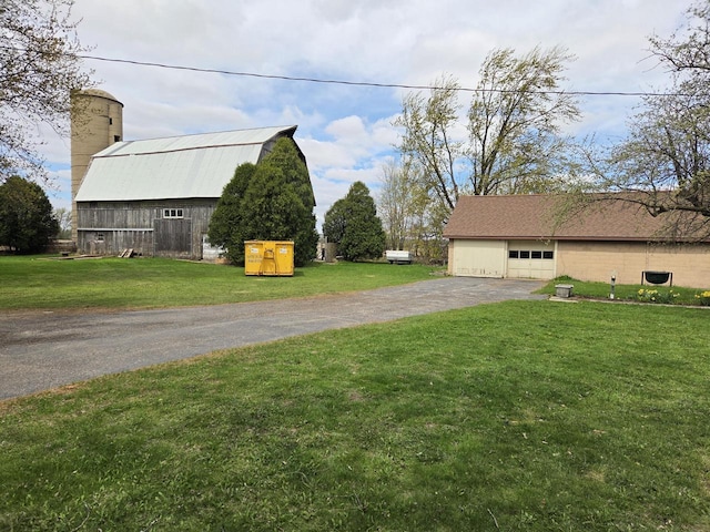 5986 Marsh Rd, Elkhorn, WI 53121 - view of side of property with a barn, driveway, a garage, an outdoor structure, and a yard