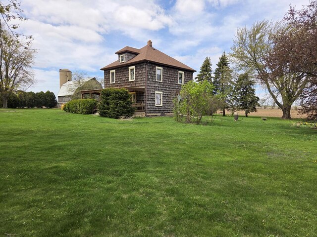 5986 Marsh Rd, Elkhorn, WI 53121 - view of side of home featuring a chimney and a yard