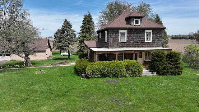 5986 Marsh Rd, Elkhorn, WI 53121 - exterior space with a shingled roof, a yard, and a porch