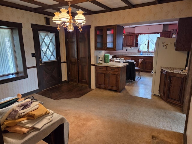 5986 Marsh Rd, Elkhorn, WI 53121 - foyer with wallpapered walls, a chandelier, light carpet, and beam ceiling