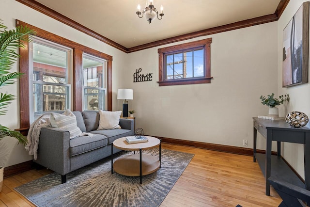 817 E Otjen St, Milwaukee, WI 53207 - living room featuring light wood-style floors, ornamental molding, baseboards, and a chandelier