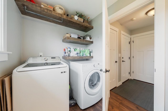 washroom with dark wood-style floors and washing machine and clothes dryer