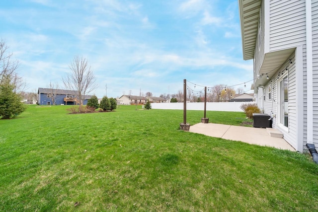 view of yard with a patio, central air condition unit, and fence