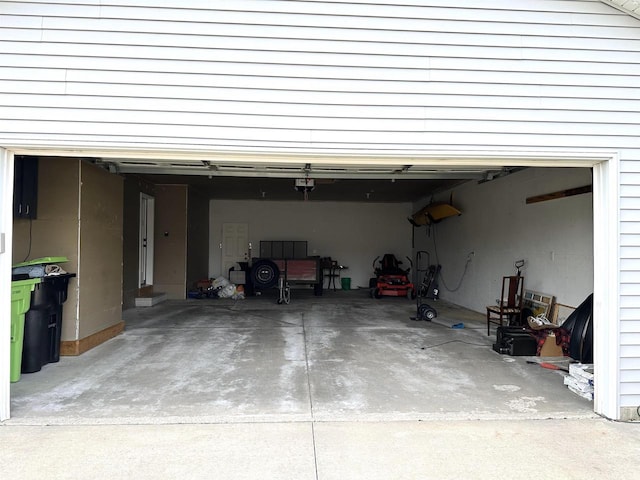garage with a garage door opener and driveway