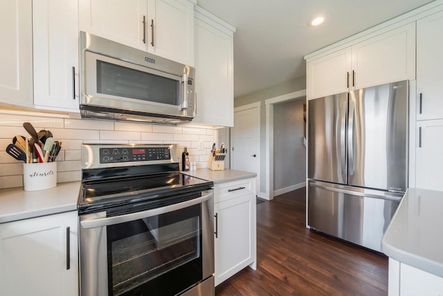 kitchen featuring light countertops, stainless steel appliances, and white cabinetry