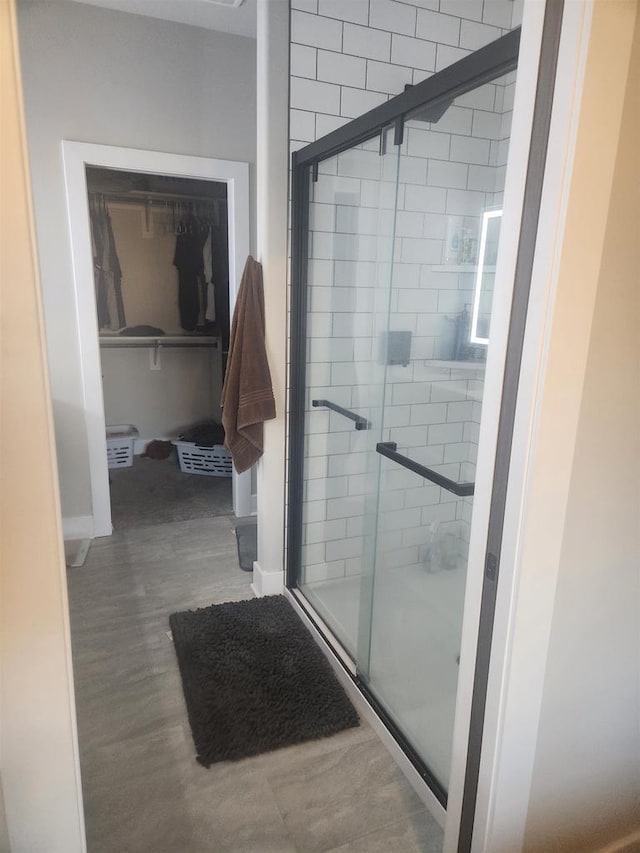 bathroom featuring baseboards and a stall shower
