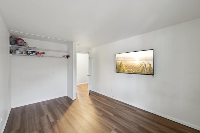 empty room featuring baseboards and wood finished floors
