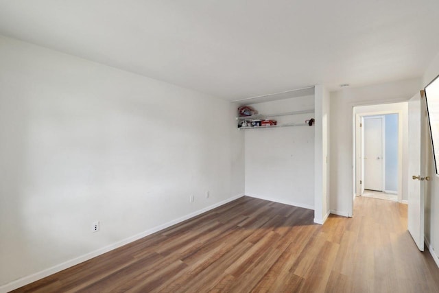 empty room featuring baseboards and wood finished floors