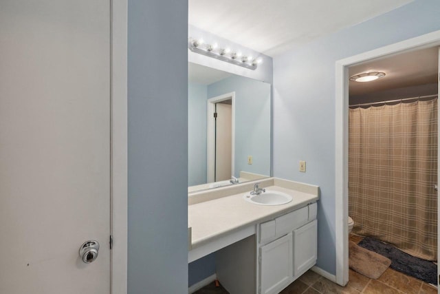 bathroom with vanity, toilet, and curtained shower