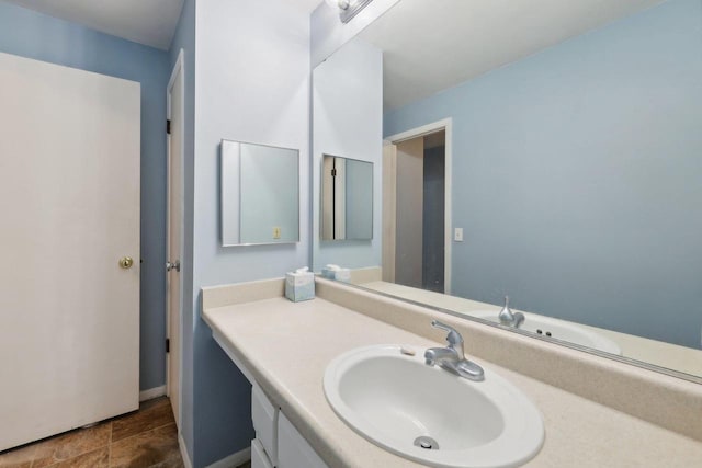 bathroom featuring vanity and baseboards