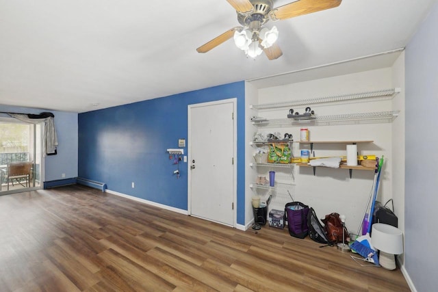 unfurnished living room with baseboards, ceiling fan, and wood finished floors