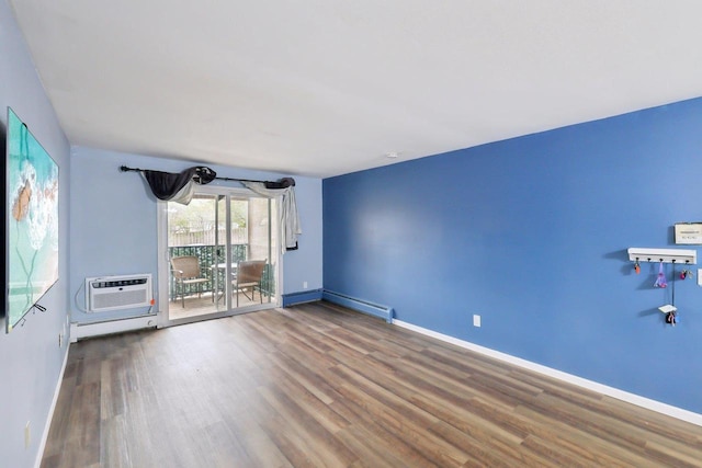 empty room with wood finished floors, baseboards, baseboard heating, a wall mounted AC, and a baseboard heating unit