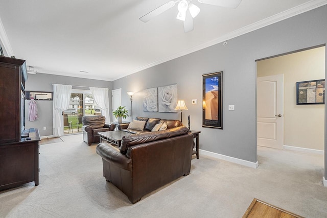 living area featuring baseboards, ornamental molding, light carpet, and a ceiling fan