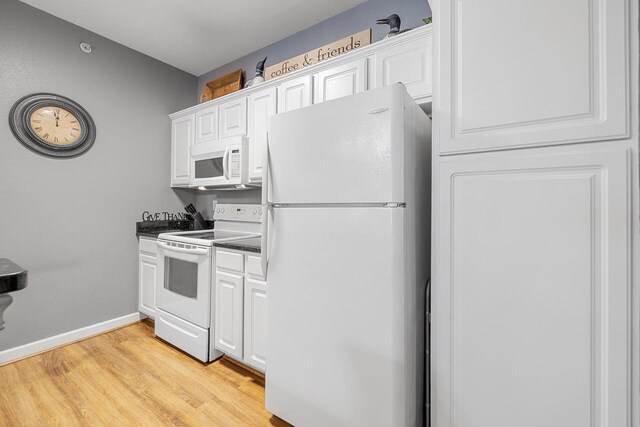 kitchen featuring dark countertops, white appliances, baseboards, white cabinets, and light wood finished floors